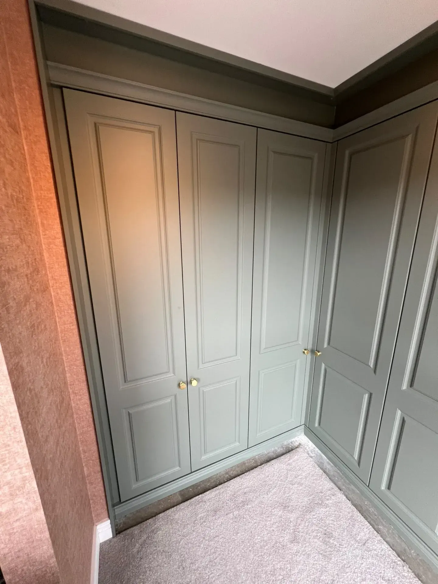 Corner of a painted fitted wardrobe