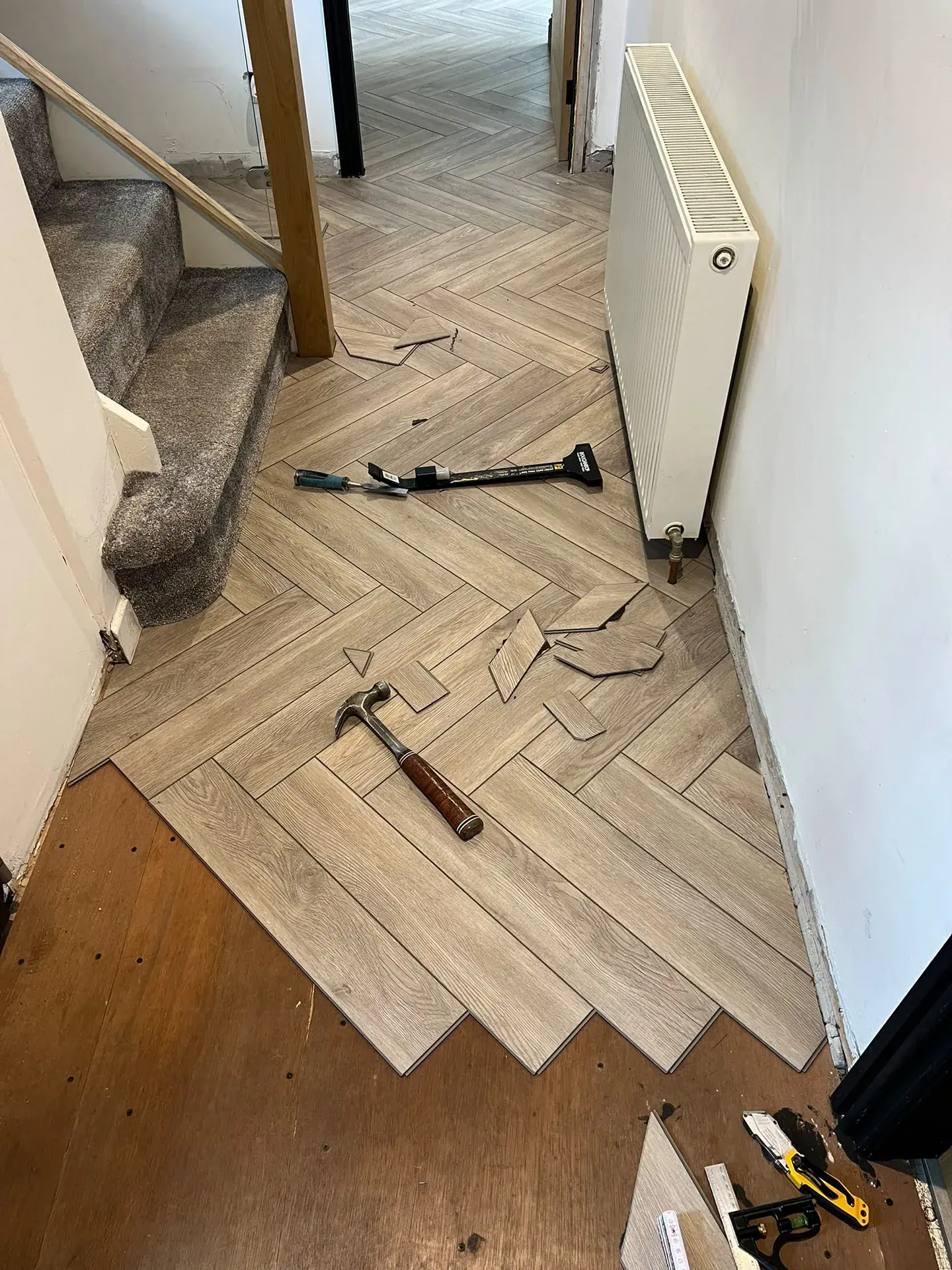 Herringbone floor being fitted around a doorway