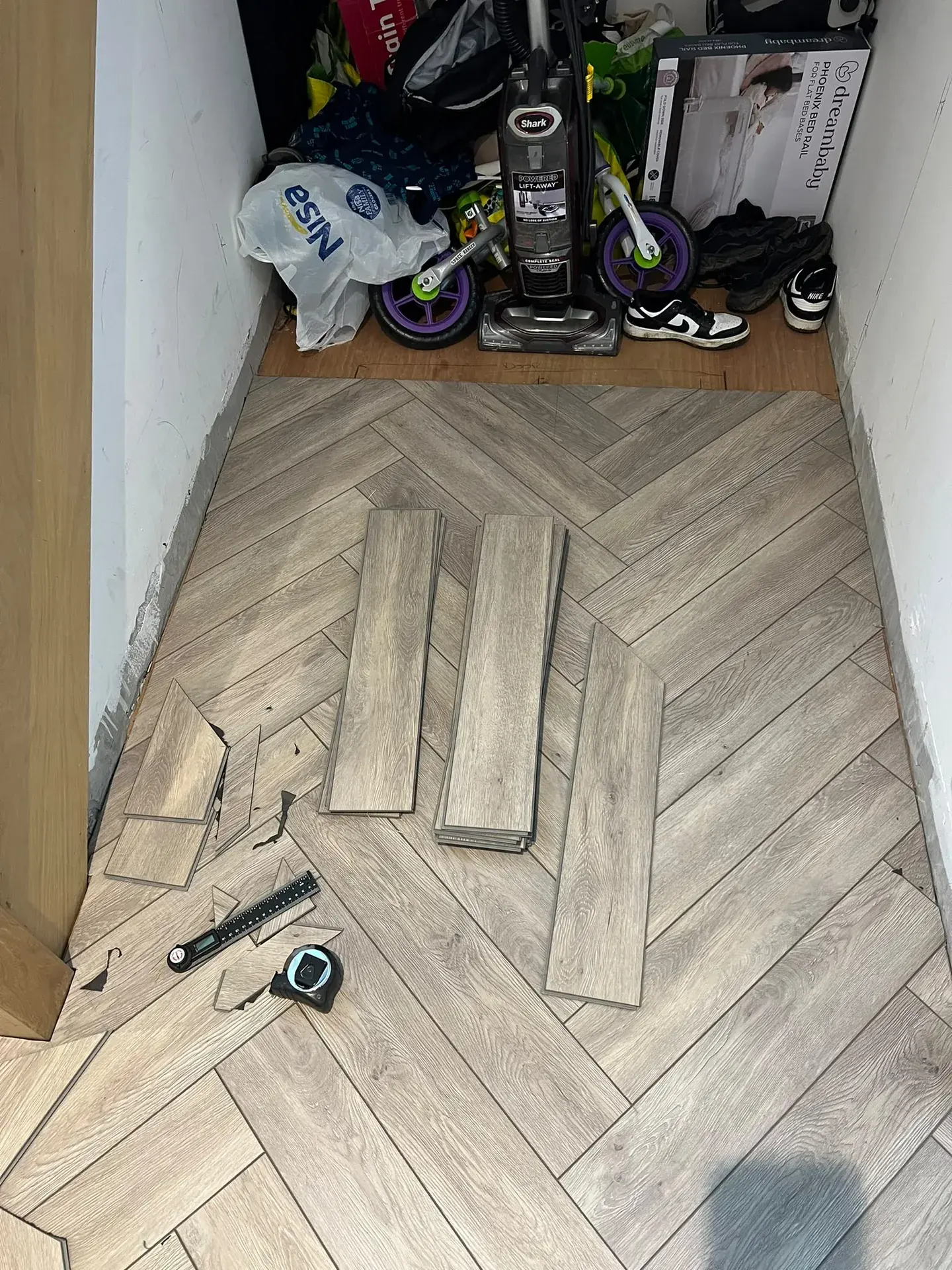 Herringbone flooring with tools during installation