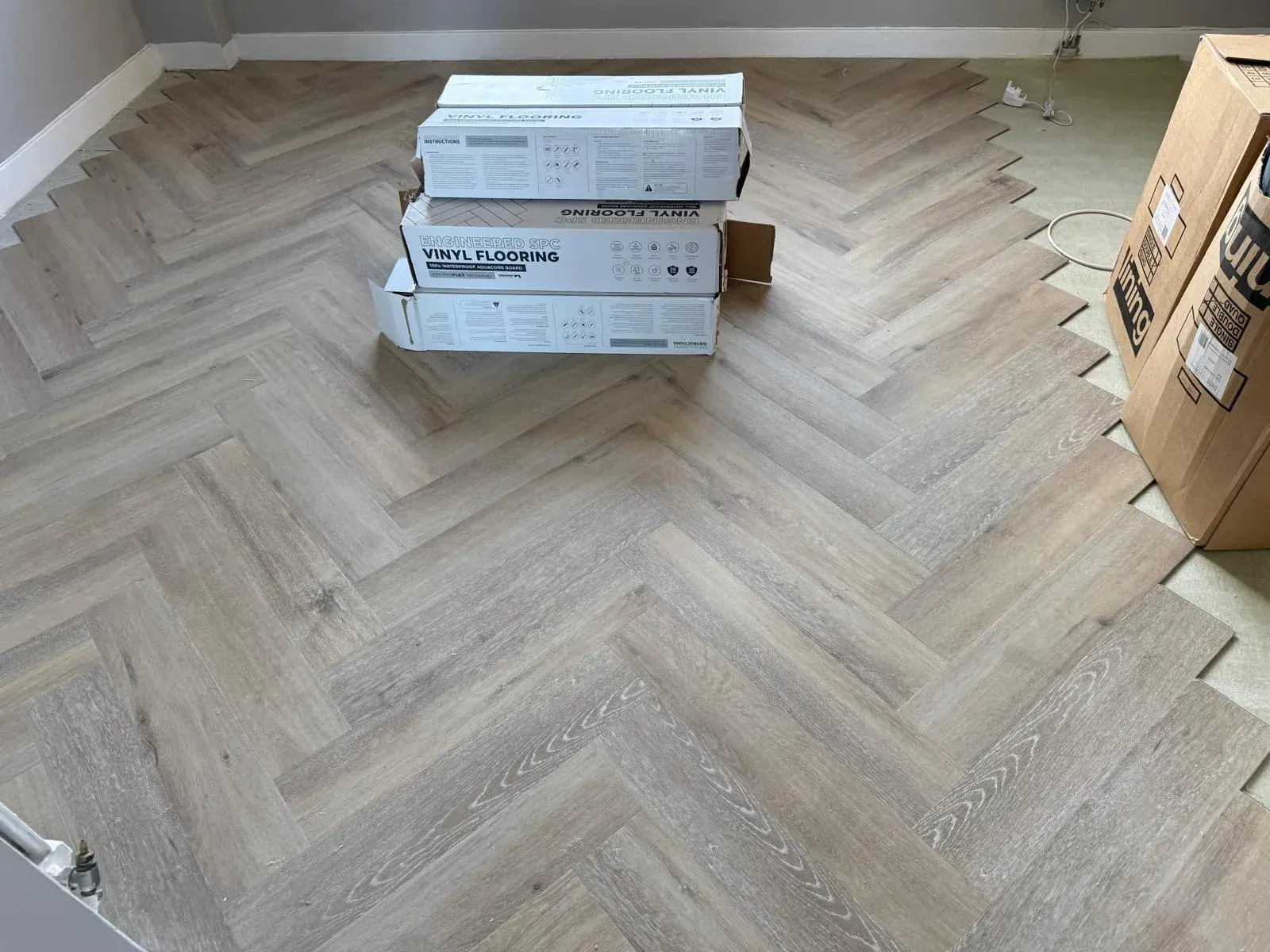 New flooring during installation with material boxes