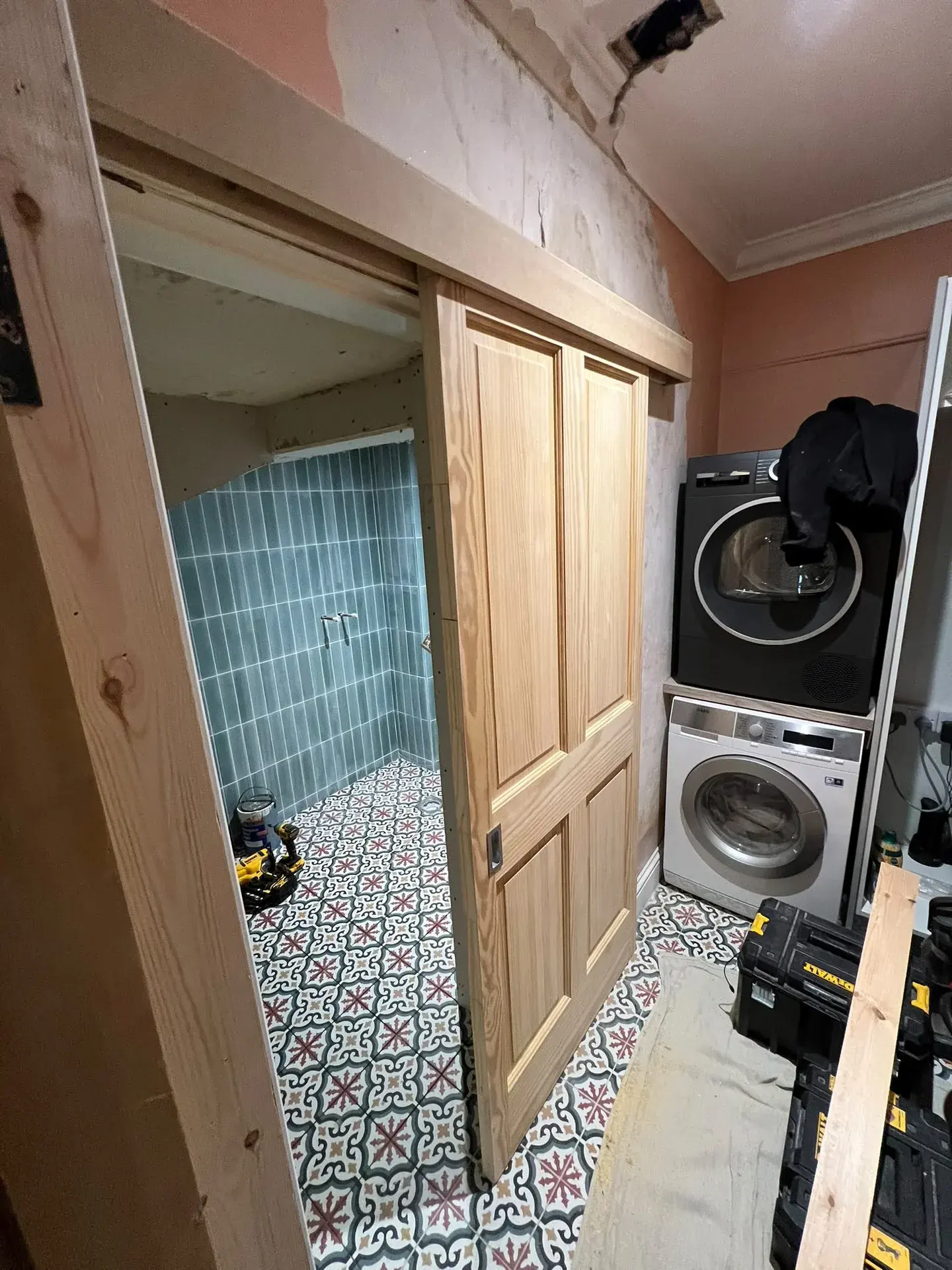 Timber doors beside stacked laundry appliances