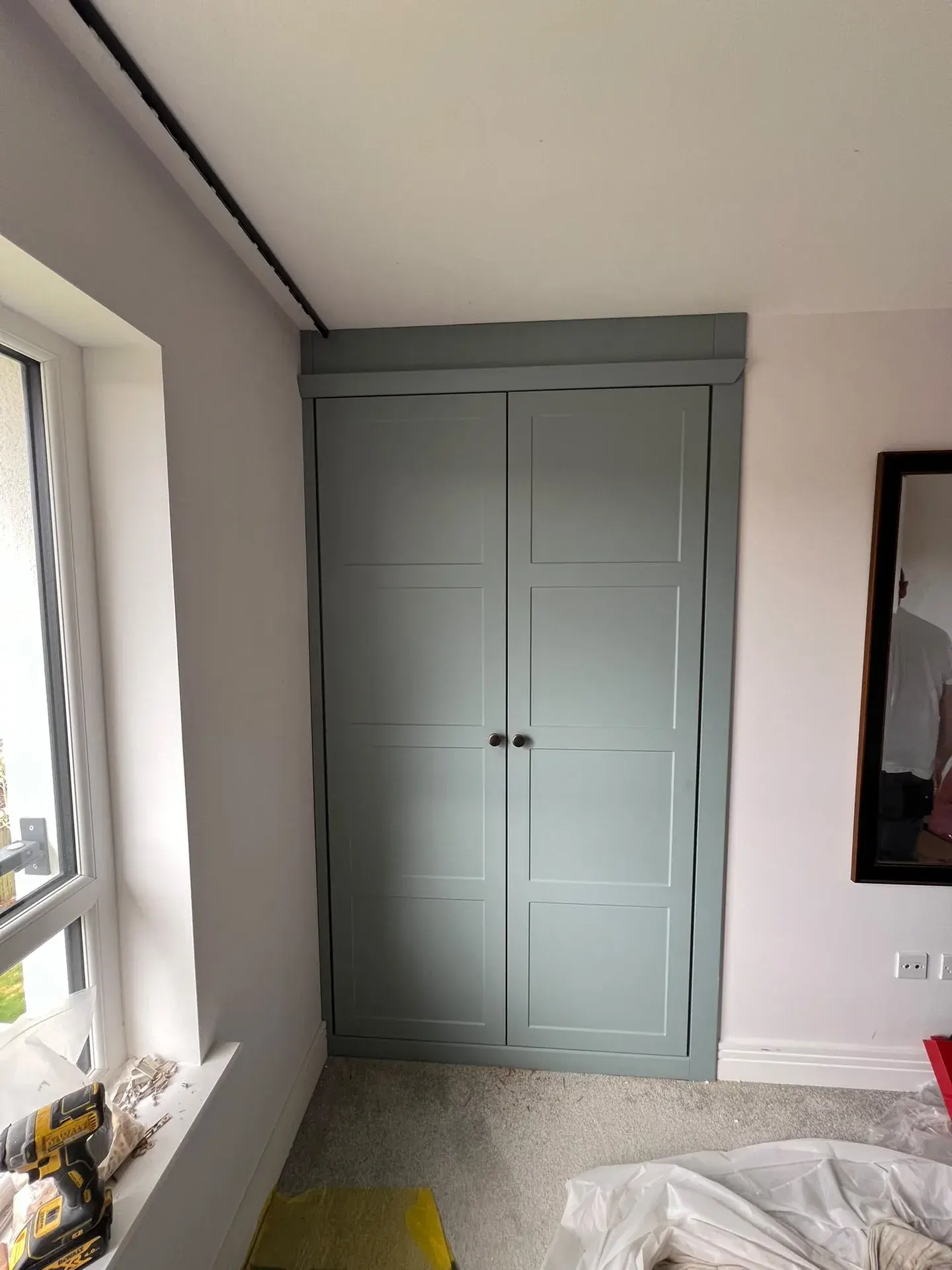 Painted fitted wardrobe with panelled doors