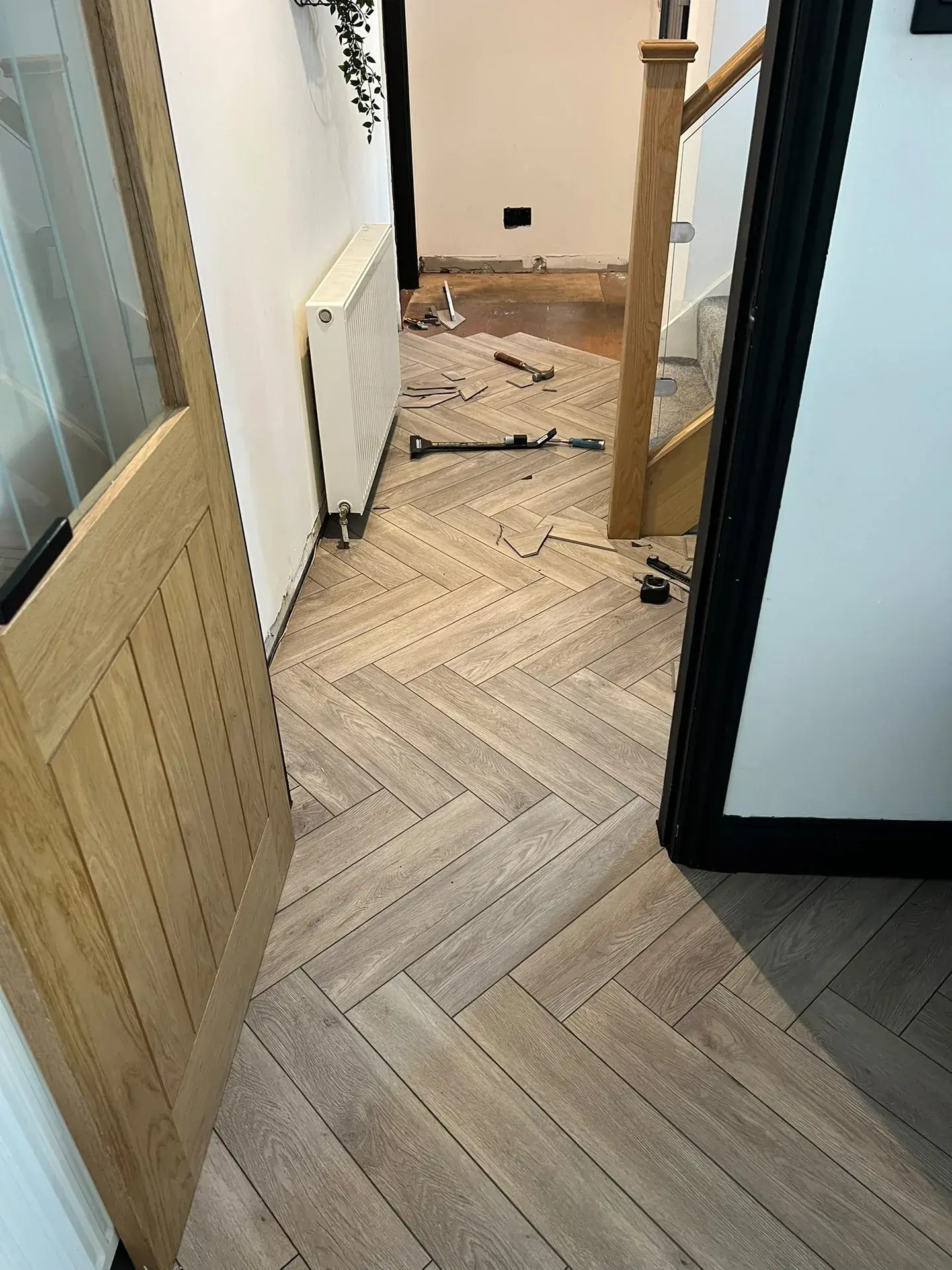 Herringbone floor extending through an interior doorway