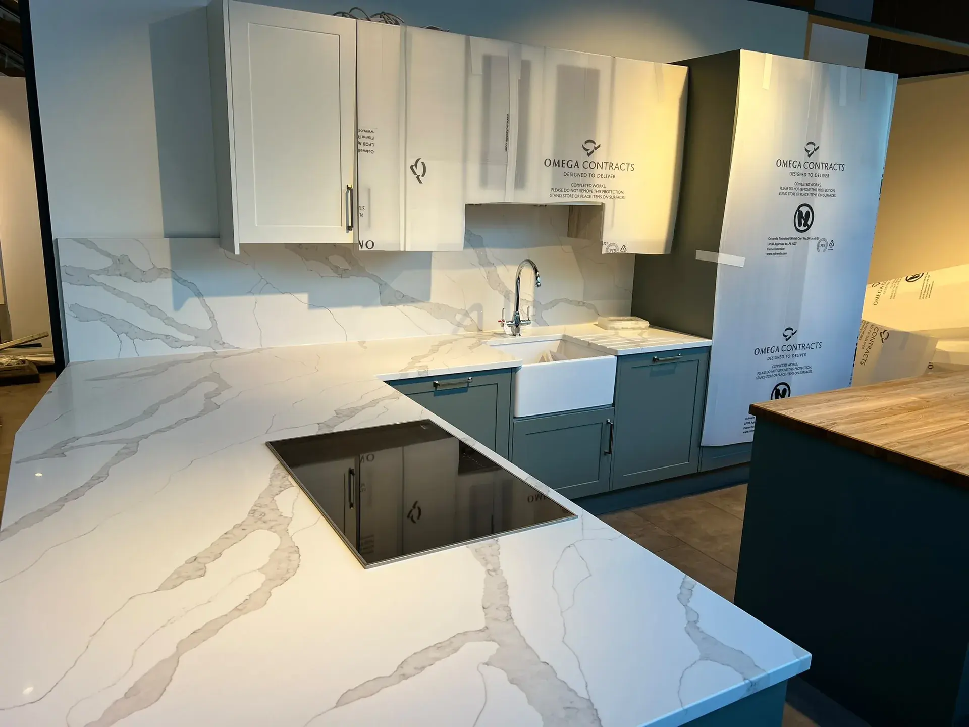 Pale veined kitchen worktop with hob and sink areas